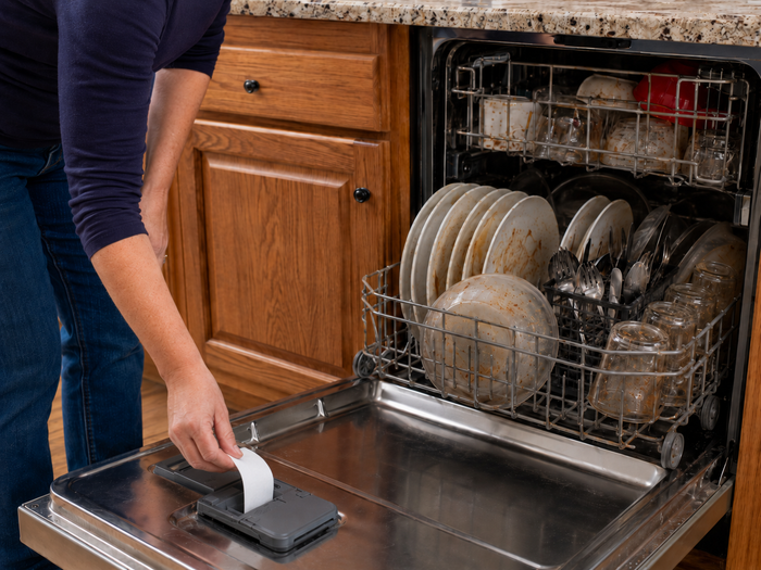 Placing cleaning sheets into the dishwasher compartment